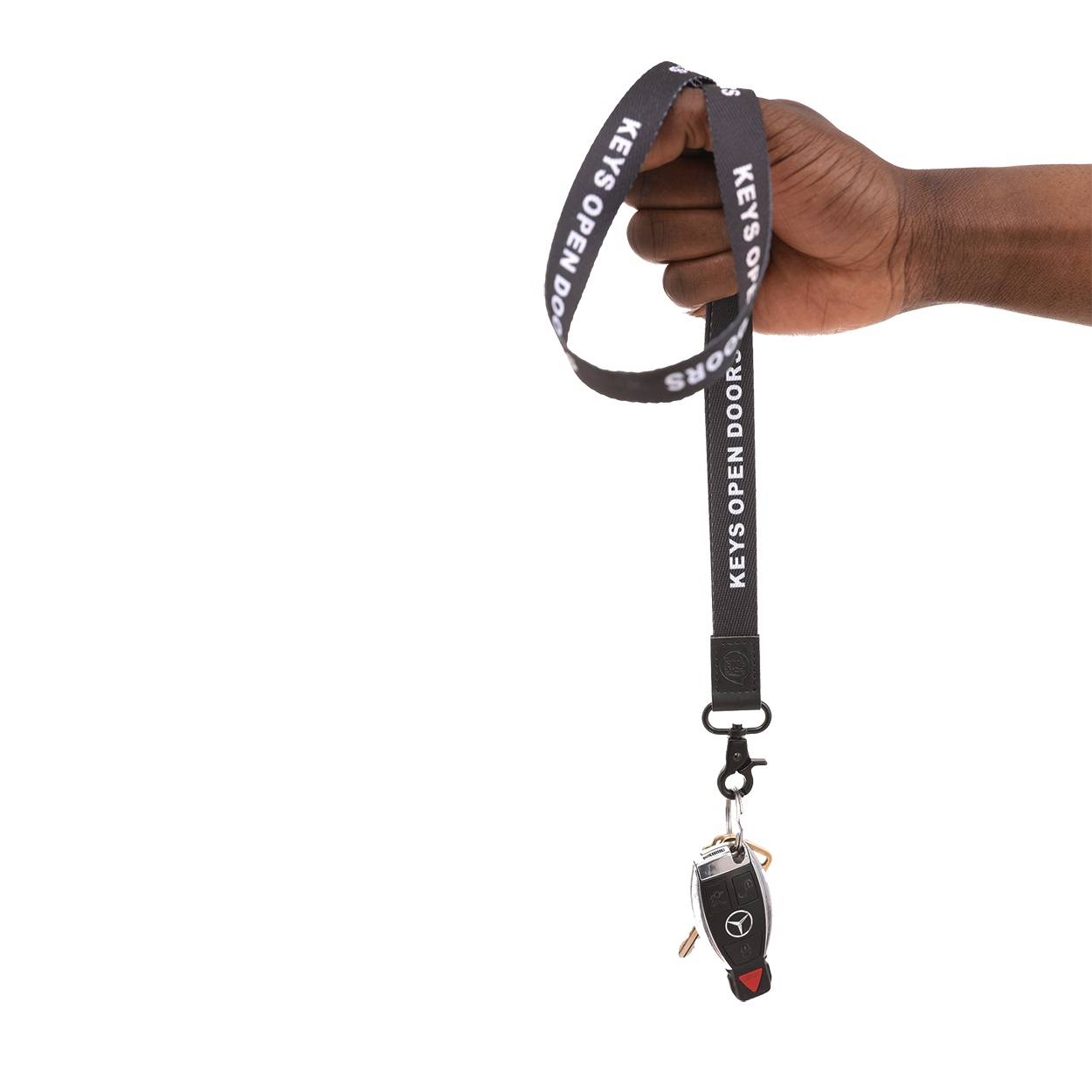 Black lanyard with car keychain held by a hand on a white background