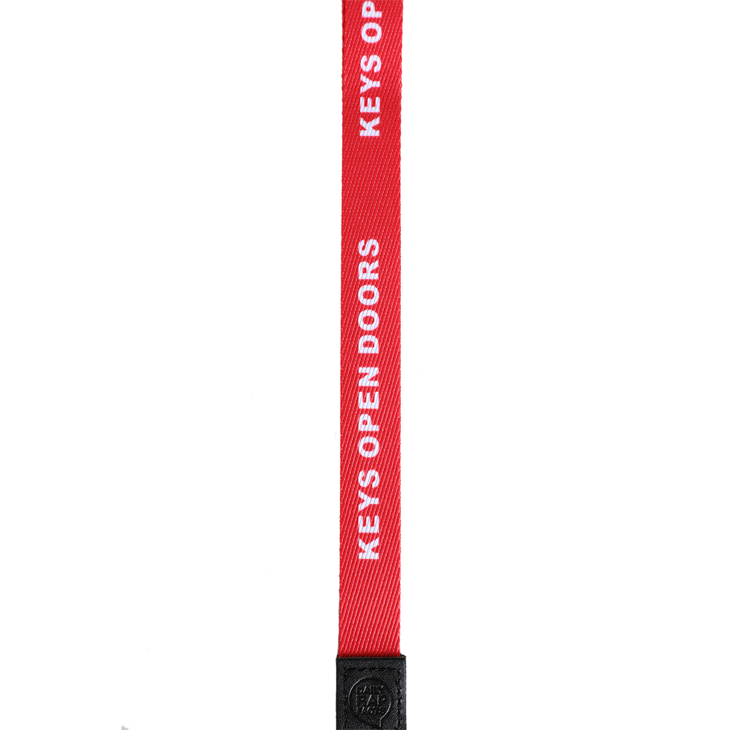 Red lanyard with 'Keys Open Doors' text on a white background
