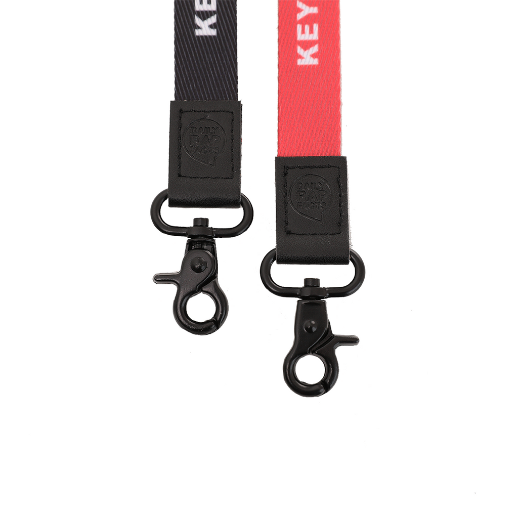 Two keychains with black and red straps on a white background