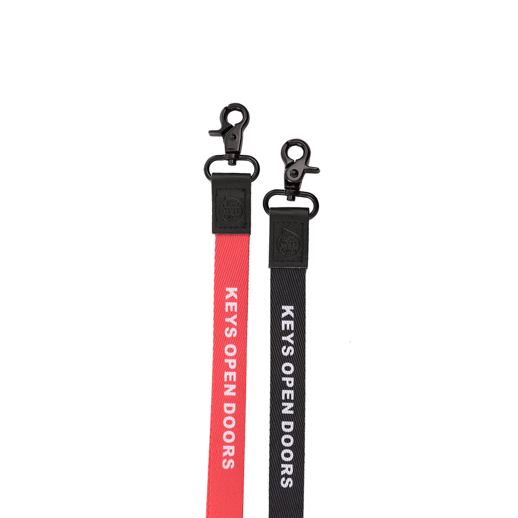Two keychains with 'Keys Open Doors' text on a white background
