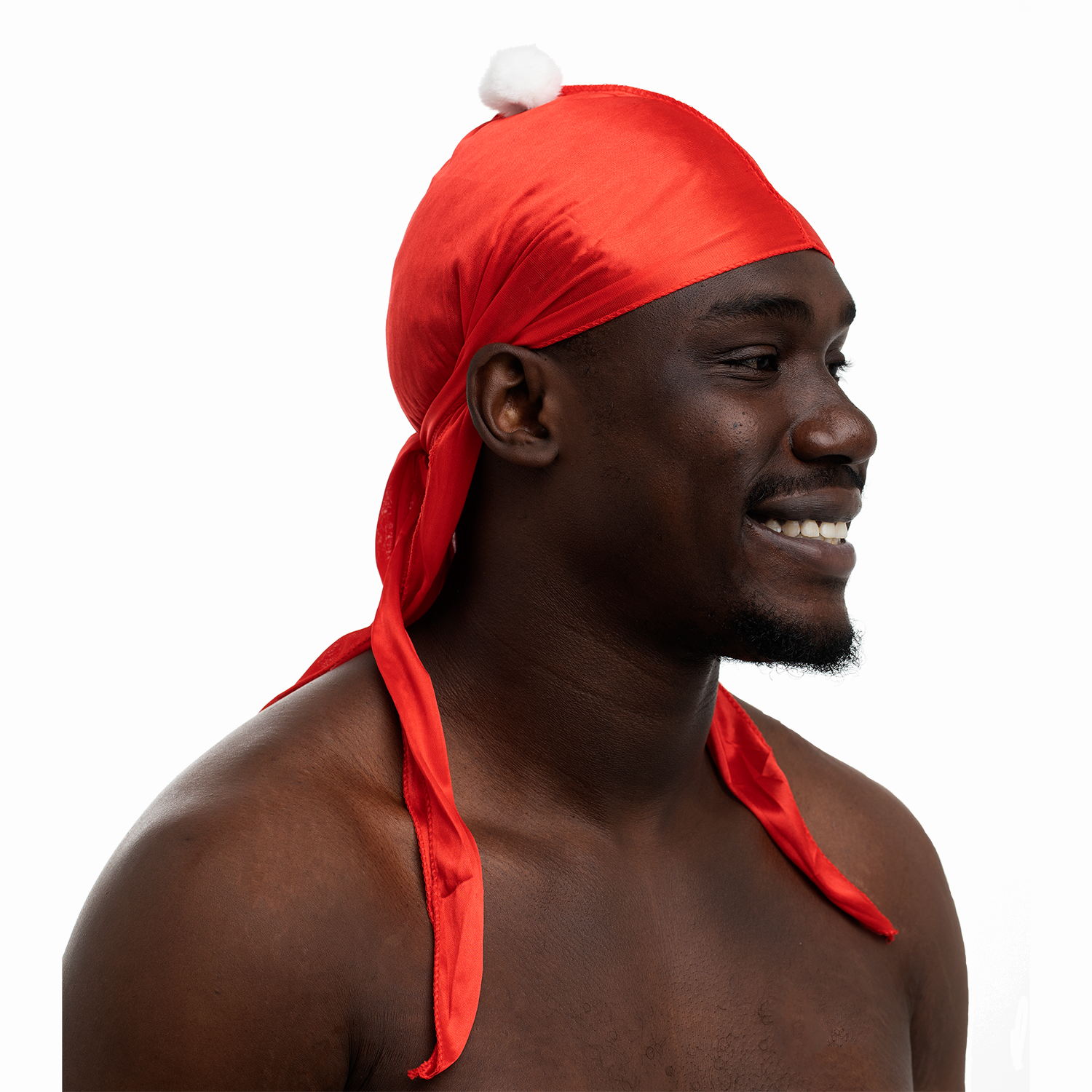 Joel Sagbo wearing a Santa Durag with a white pom-pom on a white background